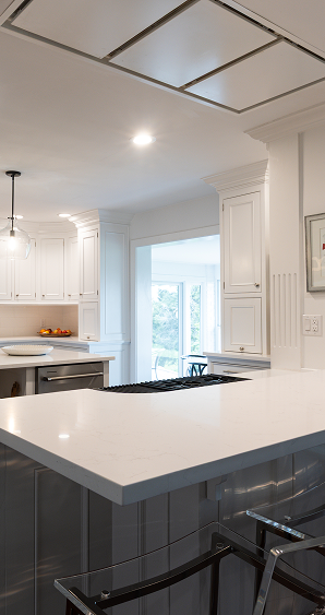 White quartz waterfall island countertop with bar seating