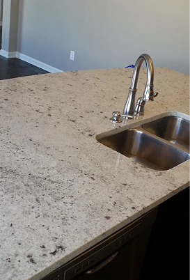 Close-up of granite countertop with sink and faucet