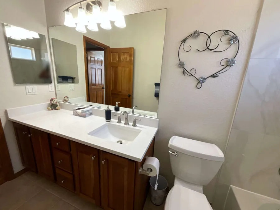 Completed bathroom remodel with a new vanity, mirror and light fixture