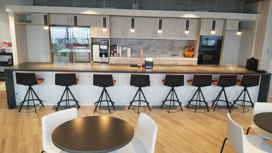 Commercial break room with an extended counter, bar seating and a coffee station
