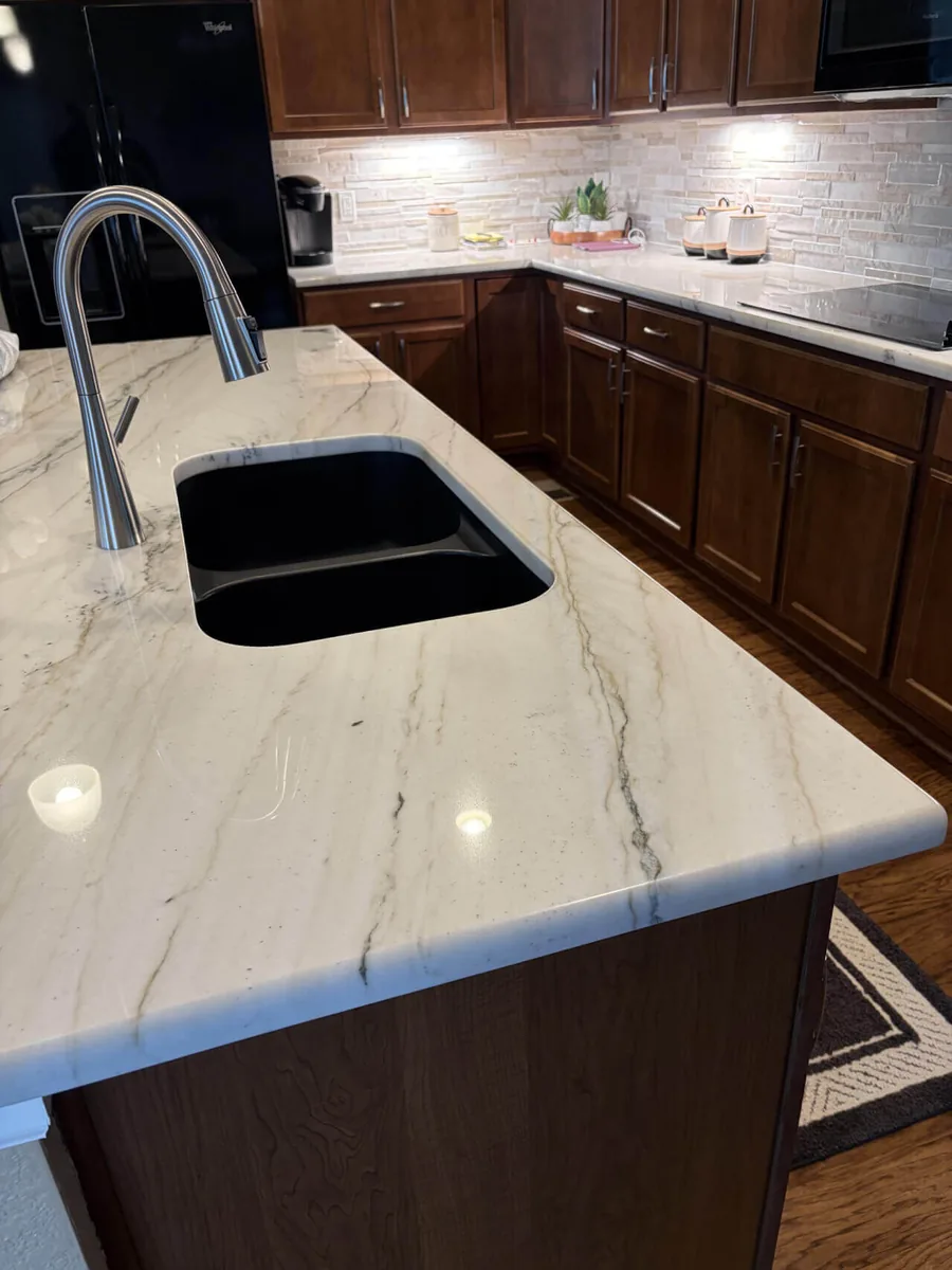 Durable quartz countertop with an undermount sink in a dark wood cabinet kitchen