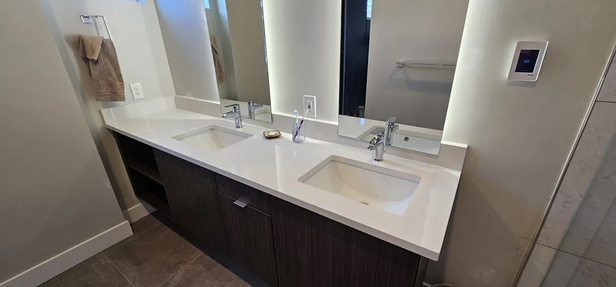 Floating double vanity with a quartz countertop and dark wood cabinetry