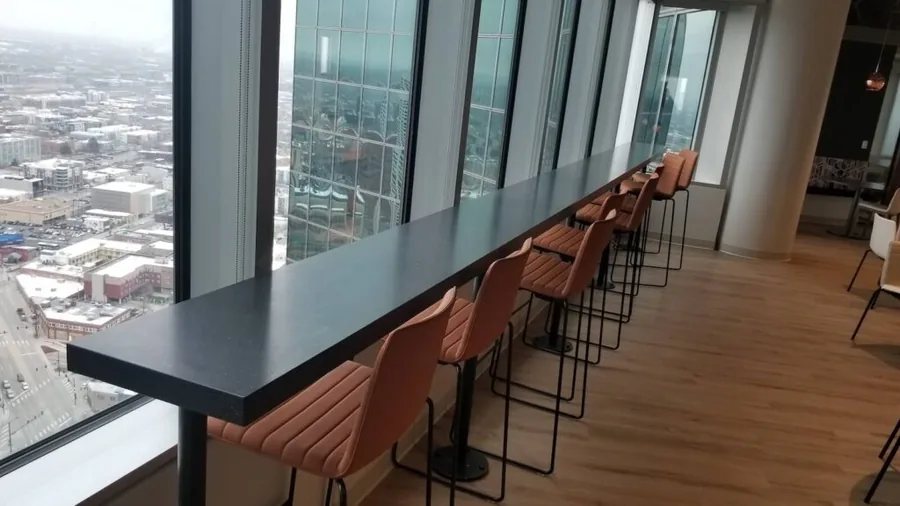 High-rise office bar counter with seating overlooking the city skyline