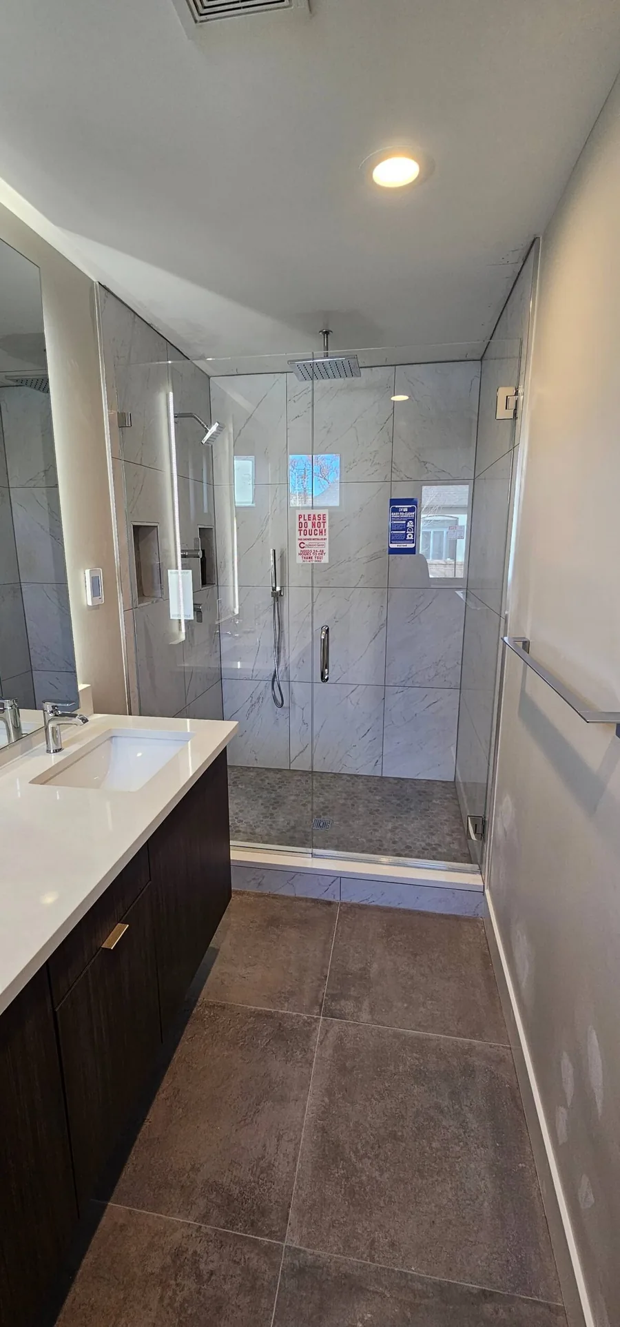 Spa-style bathroom with a double vanity and a glass walk-in shower