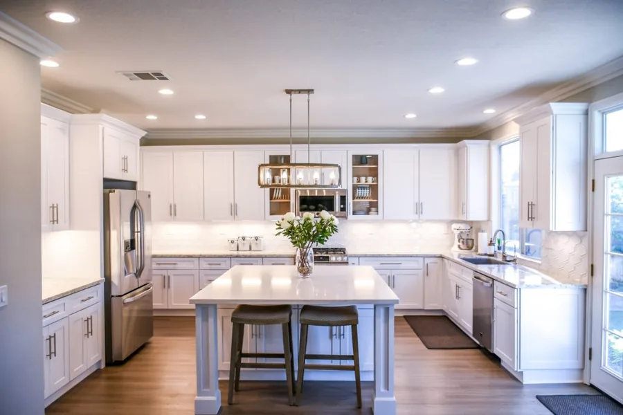 Bright white kitchen with a center island and pendant lighting in a Denver home